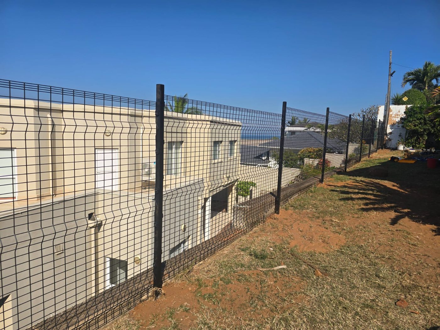 New Clear View fencing installed along the property boundary